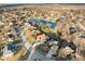 An aerial view depicts a serene lake surrounded by houses in a quiet neighborhood at 2487 Wayward Wind Dr, Indianapolis, IN 46239