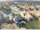 A high angle aerial view of an elegant home, landscaped yard, in-ground pool, and a neighborhood of similar houses at 2487 Wayward Wind Dr, Indianapolis, IN 46239
