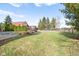 Large backyard with green grass, a partially covered pool, and an iron fence at 2487 Wayward Wind Dr, Indianapolis, IN 46239