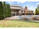 Backyard view of the home with a partially covered pool, patio and mature trees at 2487 Wayward Wind Dr, Indianapolis, IN 46239
