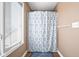 Bathroom featuring a window with blinds and a decorative shower curtain at 2487 Wayward Wind Dr, Indianapolis, IN 46239