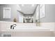 A tiled tub offers a serene bathing experience in this bathroom at 2487 Wayward Wind Dr, Indianapolis, IN 46239