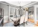 Charming dining area features a wood table with seating for six, a chandelier, and a large window at 2487 Wayward Wind Dr, Indianapolis, IN 46239