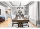Formal dining room with large table, chairs, modern chandelier, and natural light at 2487 Wayward Wind Dr, Indianapolis, IN 46239