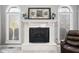 Cozy fireplace featuring elegant white mantle, decorative artwork, and ornate screen at 2487 Wayward Wind Dr, Indianapolis, IN 46239
