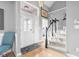 Bright foyer with hardwood floors, staircase, and elegant glass front door at 2487 Wayward Wind Dr, Indianapolis, IN 46239