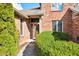 Inviting front entrance with a decorative glass door and manicured shrubbery at 2487 Wayward Wind Dr, Indianapolis, IN 46239