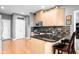 Modern kitchen with stainless steel appliances, breakfast bar, and hardwood floors at 2487 Wayward Wind Dr, Indianapolis, IN 46239