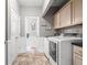 Well-organized laundry room with modern washer and dryer, plus ample cabinet space at 2487 Wayward Wind Dr, Indianapolis, IN 46239