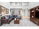 Open-concept living room with high ceilings, large sofa, and view of the dining area at 2487 Wayward Wind Dr, Indianapolis, IN 46239