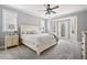 Tranquil bedroom with soft colors, a ceiling fan, and a door leading to the outside at 2487 Wayward Wind Dr, Indianapolis, IN 46239