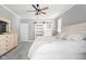 Light-filled bedroom with a ceiling fan, sliding barn door, and elegant neutral decor at 2487 Wayward Wind Dr, Indianapolis, IN 46239