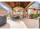 Covered patio with wood ceiling, ceiling fan, brick columns and an outdoor table set at 2487 Wayward Wind Dr, Indianapolis, IN 46239