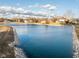 Scenic view of a pond surrounded by lush landscaping and neighboring homes, reflecting the tranquil community ambiance at 2487 Wayward Wind Dr, Indianapolis, IN 46239