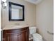 Powder room featuring vanity with granite countertop and a framed mirror at 2489 Woodsway Dr, Greenwood, IN 46143