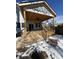 A spacious wooden back deck with an open ceiling and a ceiling fan overlooking the snowy yard at 2819 Walker Ave, Indianapolis, IN 46203