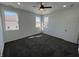 Bright bedroom with three windows, plush carpet, a ceiling fan, and white trim at 2819 Walker Ave, Indianapolis, IN 46203