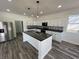 Contemporary kitchen with white cabinets, stainless steel appliances, and a central island with pendant lighting at 2819 Walker Ave, Indianapolis, IN 46203