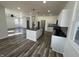 Bright, open kitchen with an island, stainless steel appliances, modern white cabinets, and dark countertops at 2819 Walker Ave, Indianapolis, IN 46203