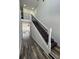 Modern staircase with dark wood steps, white risers, and elegant wrought iron railings at 2819 Walker Ave, Indianapolis, IN 46203