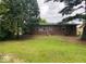 Spacious backyard with ample lawn space and mature trees offering privacy and shade at 2863 W 30Th St, Indianapolis, IN 46222