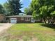 Charming brick ranch home featuring an attached garage, manicured lawn, and mature trees at 2863 W 30Th St, Indianapolis, IN 46222