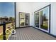 View of the balcony with sliding glass doors and black metal railing overlooking neighborhood homes and tree lined street at 3238 Guilford Ave, Indianapolis, IN 46205