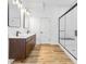 Modern bathroom boasts a double vanity with sleek faucets and a glass-enclosed shower at 3238 Guilford Ave, Indianapolis, IN 46205