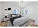 Bedroom featuring modern decor, with hardwood floors and natural light at 3238 Guilford Ave, Indianapolis, IN 46205