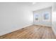 Bright, minimalist bedroom features two large windows and sleek flooring at 3238 Guilford Ave, Indianapolis, IN 46205