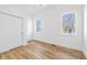 Bright bedroom with two windows, wood floors, white walls, white trim and a white closet door at 3238 Guilford Ave, Indianapolis, IN 46205
