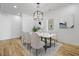 Dining room with contemporary lighting, hardwood floors, and seating for six at 3238 Guilford Ave, Indianapolis, IN 46205