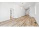 Spacious living room with neutral tones, wood floors, and multiple access doors at 3238 Guilford Ave, Indianapolis, IN 46205