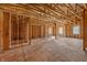 View of unfinished home interior with framing, exposed beams, plywood floor and two visible windows at 3238 Guilford Ave, Indianapolis, IN 46205