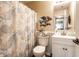 Well-lit bathroom with a seashell-themed shower curtain and a white vanity at 4033 Oak Trail Dr, Indianapolis, IN 46237