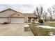 Cozy brick home featuring an attached two car garage and well maintained front yard and landscaping at 4033 Oak Trail Dr, Indianapolis, IN 46237