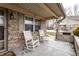 Welcoming front porch featuring classic rocking chairs, brick facade, and a peaceful spot for relaxing at 4033 Oak Trail Dr, Indianapolis, IN 46237