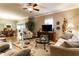 Comfortable living room with hardwood floors, ceiling fan, and a view into the dining area at 4033 Oak Trail Dr, Indianapolis, IN 46237