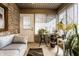 Charming sun room with brick walls, neutral furniture, and bright natural light streaming through the windows at 4033 Oak Trail Dr, Indianapolis, IN 46237