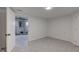 Basement featuring neutral walls, updated flooring, and a doorway leading to another room at 4139 N Grand Ave, Indianapolis, IN 46226