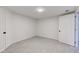 Finished basement area with light gray wood-look flooring and white walls at 4139 N Grand Ave, Indianapolis, IN 46226