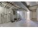 Unfinished basement with updated flooring, visible ductwork, and exposed plumbing system at 4139 N Grand Ave, Indianapolis, IN 46226