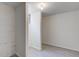 Finished basement with gray flooring and white walls, window and support beams at 4139 N Grand Ave, Indianapolis, IN 46226