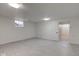Spacious basement featuring neutral walls, updated flooring, and a doorway leading to another room at 4139 N Grand Ave, Indianapolis, IN 46226