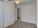 Bright bedroom featuring neutral carpet, closet, a peek into the hallway, and ample natural light at 4139 N Grand Ave, Indianapolis, IN 46226