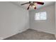 Cozy bedroom features neutral carpet, ceiling fan, and a window for natural light at 4139 N Grand Ave, Indianapolis, IN 46226