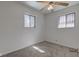 Well-lit bedroom with neutral carpet, two windows, ceiling fan, and a fresh, clean aesthetic at 4139 N Grand Ave, Indianapolis, IN 46226