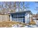 Exterior view of the detached garage with white siding and a light blue trim and glass-paneled garage door at 4139 N Grand Ave, Indianapolis, IN 46226