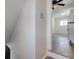 Hallway view showcasing neutral walls, updated flooring and a ceiling fan in the adjacent room at 4139 N Grand Ave, Indianapolis, IN 46226