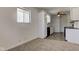 Bright kitchen featuring white cabinetry, dark countertops, stainless steel sink, and a window for natural light at 4139 N Grand Ave, Indianapolis, IN 46226